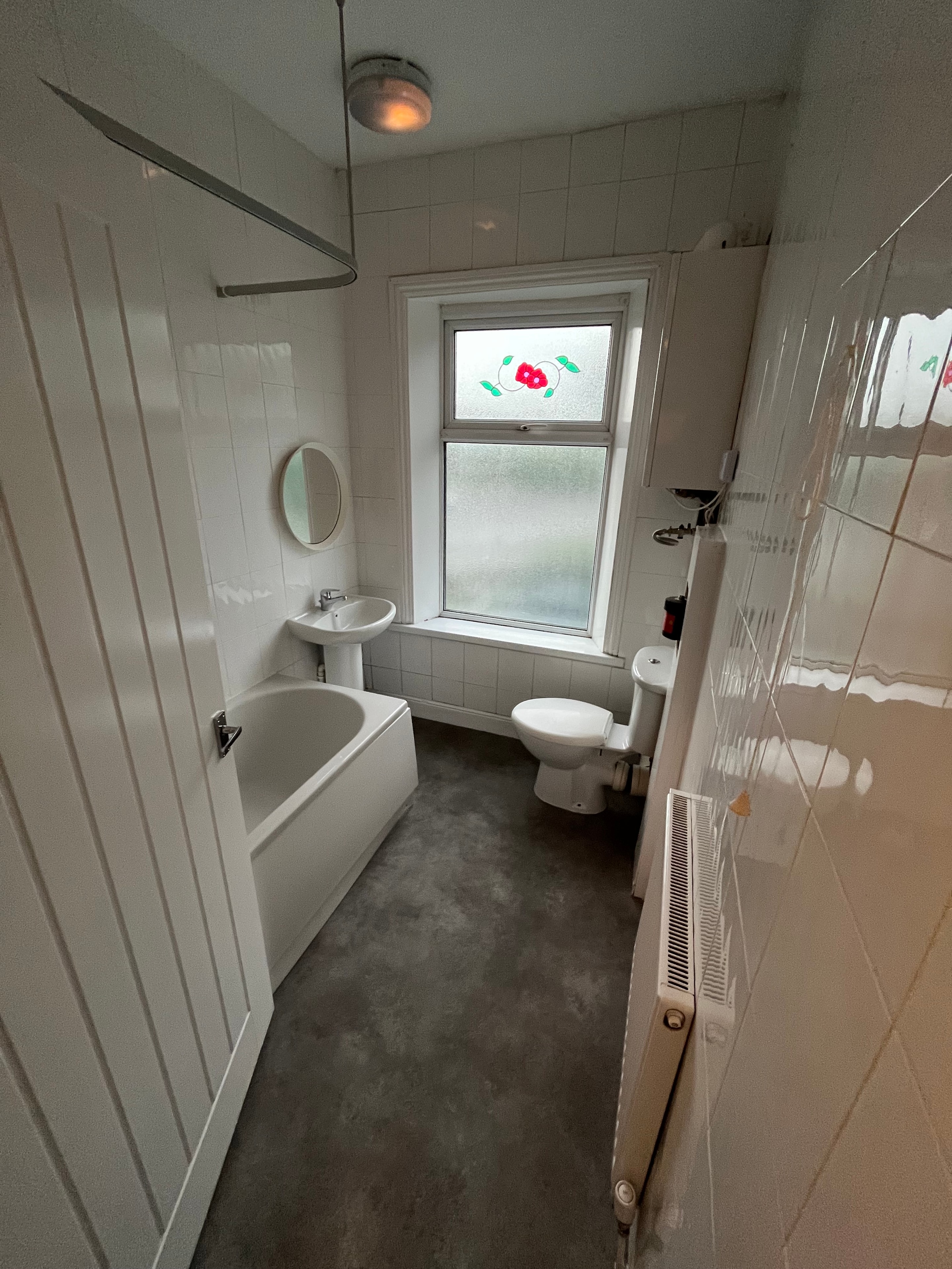 Bathroom with bathtub and frosted window